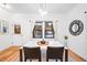 Bright dining room features a marble table, modern light fixture, and window views at 950 Tenderfoot Dr, Larkspur, CO 80118