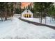 Charming Craftsman home with snowy front yard and attached garage at 950 Tenderfoot Dr, Larkspur, CO 80118