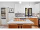 Modern kitchen island with white quartz countertop and light wood cabinets at 950 Tenderfoot Dr, Larkspur, CO 80118