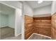 Wood paneled closet with open shelving and a light gray wood floor at 7020 Canosa Ct, Westminster, CO 80030