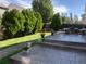 Landscaped backyard with greenery, patio seating, and steps leading to the lawn at 19731 E 40Th Ave, Denver, CO 80249