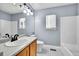 Clean bathroom featuring bright wall paint, tiled floors, and a large bathtub and shower at 19731 E 40Th Ave, Denver, CO 80249