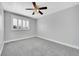 Cozy bedroom featuring a ceiling fan, window with blinds, and soft carpet at 19731 E 40Th Ave, Denver, CO 80249