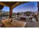 Inviting backyard patio with stone fireplace, pergola, and cozy seating area perfect for outdoor entertaining at 2618 S Kilmer Ct, Denver, CO 80228