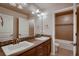 Bathroom boasts a double vanity, granite countertops, and mosaic tile accents, with a shower and tub combo at 2618 S Kilmer Ct, Denver, CO 80228