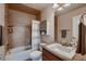Bathroom featuring tiled walls, a shower-tub combination with a curtain, and a vanity with ample storage at 2618 S Kilmer Ct, Denver, CO 80228