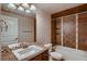 This elegant bathroom features a tile backsplash and a tub-shower combo, creating a relaxing retreat at 2618 S Kilmer Ct, Denver, CO 80228