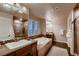 Luxurious bathroom features a soaking tub, a separate shower, and double sinks with granite countertops at 2618 S Kilmer Ct, Denver, CO 80228