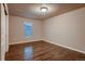 This cozy bedroom features a window and wood-style floors, perfect for a relaxing retreat at 2618 S Kilmer Ct, Denver, CO 80228