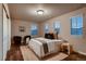 Well-lit bedroom showcasing wood floors, modern decor, and a cozy atmosphere at 2618 S Kilmer Ct, Denver, CO 80228