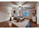 Spacious bedroom featuring a ceiling fan, hardwood floors, and a comfortable bed with stylish decor at 2618 S Kilmer Ct, Denver, CO 80228