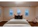 Spacious bedroom featuring three large windows and a stylishly decorated bed at 2618 S Kilmer Ct, Denver, CO 80228