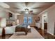 Bedroom showcasing hardwood floors, large windows, and neutral decor providing an inviting and relaxing space at 2618 S Kilmer Ct, Denver, CO 80228