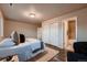 Cozy bedroom with wood floors, closet, and ensuite bathroom at 2618 S Kilmer Ct, Denver, CO 80228