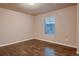 A bare bedroom with hardwood floors and a window with blinds at 2618 S Kilmer Ct, Denver, CO 80228