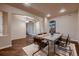Elegant dining room features hardwood floors, modern chandelier, and comfortable seating for memorable meals at 2618 S Kilmer Ct, Denver, CO 80228