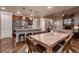 Modern kitchen open to the dining area, featuring a large island with seating, stainless appliances and hardwood floors at 2618 S Kilmer Ct, Denver, CO 80228