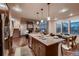 Spacious kitchen with a center island, stainless steel appliances, and open view of the living area and fireplace at 2618 S Kilmer Ct, Denver, CO 80228