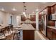 Gourmet kitchen boasts stainless steel appliances, granite countertops, and a spacious island with bar seating at 2618 S Kilmer Ct, Denver, CO 80228