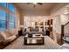 Bright living room with large windows and open floor plan flowing to the kitchen at 2618 S Kilmer Ct, Denver, CO 80228