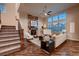 Cozy living room features a stone fireplace and bright windows, with hardwood flooring at 2618 S Kilmer Ct, Denver, CO 80228