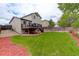 Spacious backyard with green grass, deck, and wood fence at 21486 E Crestline Ln, Centennial, CO 80015