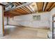 Unfinished basement featuring exposed ceiling, white plastic-covered walls, and two small windows at 21486 E Crestline Ln, Centennial, CO 80015