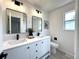 Modern bathroom featuring double sinks, sleek fixtures, and contemporary design at 21486 E Crestline Ln, Centennial, CO 80015