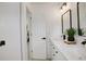 Bright bathroom features double sinks, black accents, and a view of a tiled shower at 21486 E Crestline Ln, Centennial, CO 80015