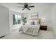 Bright bedroom with a ceiling fan, a large window, neutral carpet, and a comfortable bed at 21486 E Crestline Ln, Centennial, CO 80015