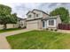 Well-maintained home featuring green lawn, mature trees, and a two-car garage at 21486 E Crestline Ln, Centennial, CO 80015