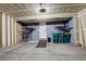 Spacious garage with storage racks, concrete floor, and access door at 21486 E Crestline Ln, Centennial, CO 80015