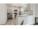 Well-lit kitchen with stainless steel appliances, quartz countertops, and white cabinetry at 21486 E Crestline Ln, Centennial, CO 80015