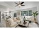 Open-concept living area featuring wood floors, comfortable seating, and access to the kitchen at 21486 E Crestline Ln, Centennial, CO 80015