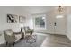 Bright living room featuring wood floors, a large window, and stylish decorative accents at 21486 E Crestline Ln, Centennial, CO 80015