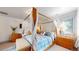 Bedroom with canopy bed, blue and white patterned bedding, and light wood furniture at 718 Locust St, Denver, CO 80220