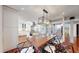 Elegant dining area with a modern chandelier and open access to the kitchen, perfect for hosting dinner parties at 718 Locust St, Denver, CO 80220