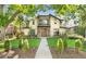 Charming two-story home with stone accents, landscaped yard, and a walkway leading to the front entrance at 718 Locust St, Denver, CO 80220