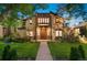 Charming two-story home with stone accents, landscaped yard, and a welcoming walkway leading to the front door at 718 Locust St, Denver, CO 80220