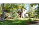 Beautiful home with manicured lawn, mature trees, and inviting front entrance at 718 Locust St, Denver, CO 80220