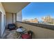 Relax on this private balcony with views of the city skyline, complete with outdoor seating and a cozy lounge area at 975 N Lincoln St # 4I, Denver, CO 80203
