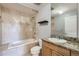 Bathroom featuring tub with tile surround, single sink vanity with granite countertop at 975 N Lincoln St # 4I, Denver, CO 80203