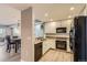 Modern kitchen with white cabinets, granite countertops, and stainless steel appliances at 975 N Lincoln St # 4I, Denver, CO 80203