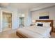 Relaxing main bedroom showcasing a modern wood bed frame, ensuite bath, and walk-in closet at 975 N Lincoln St # 4I, Denver, CO 80203