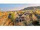 Beautiful sunset aerial view of the home featuring mature trees, and mountain views at 17294 W 60Th Ct, Arvada, CO 80403