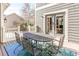 Charming back patio features an outdoor dining table set for six, perfect for entertaining guests at 17294 W 60Th Ct, Arvada, CO 80403