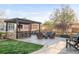 Enjoy a backyard featuring an outdoor kitchen, bar, and fire pit, perfect for entertaining at 17294 W 60Th Ct, Arvada, CO 80403