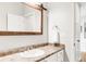 Bathroom featuring a white vanity, wood-framed mirror, and neutral countertop at 17294 W 60Th Ct, Arvada, CO 80403