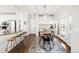 Bright breakfast nook featuring a dining table, kitchen bar, and access to the patio at 17294 W 60Th Ct, Arvada, CO 80403