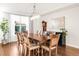 Elegant dining room with a large table, hardwood floors, and a stylish chandelier at 17294 W 60Th Ct, Arvada, CO 80403
